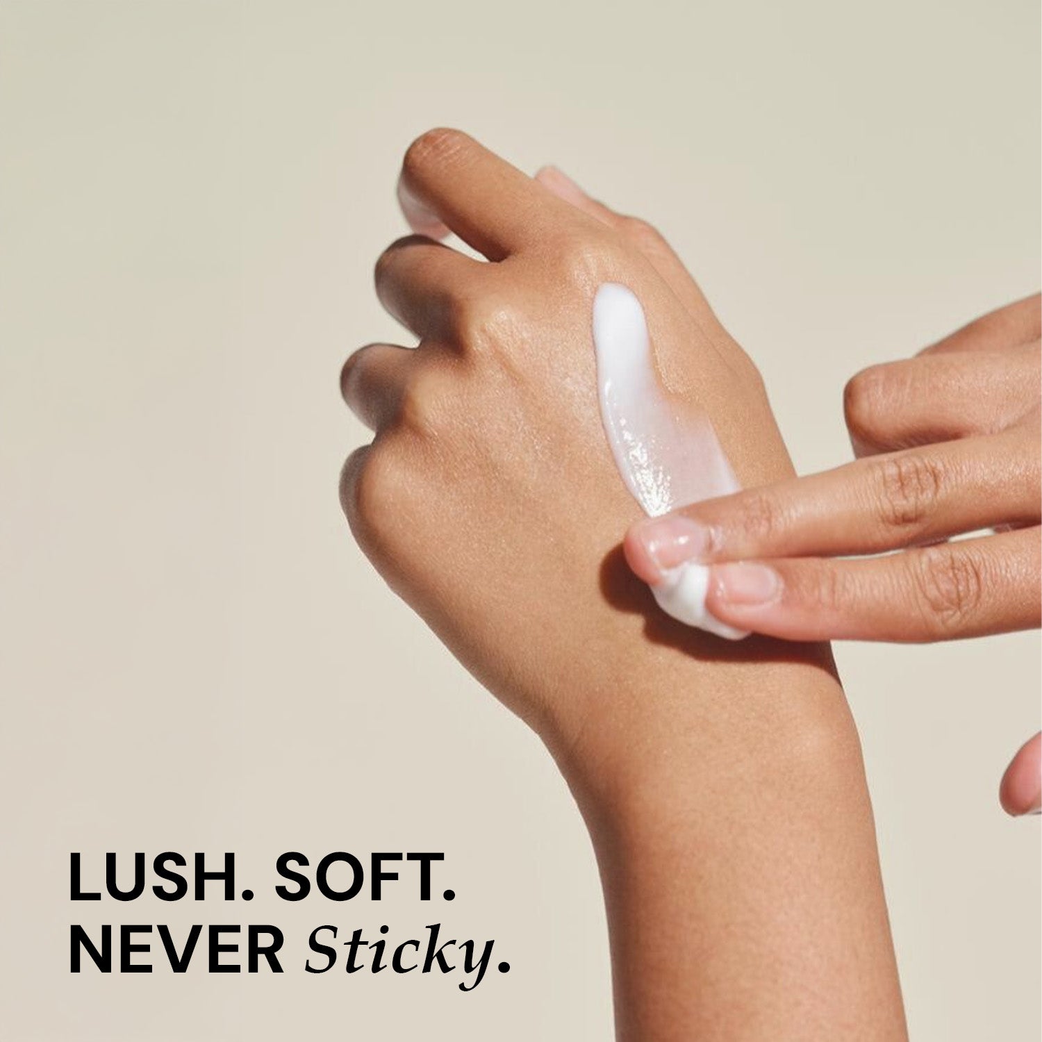 Hand applying a white cream to another hand with a beige background and text 'LUSH. SOFT. NEVER Sticky.'