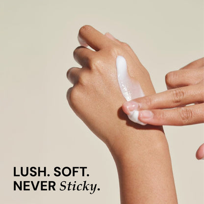  hand applying a white cream to another hand with a beige background and text 'lush. soft. never sticky.'